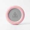 Thermostatic Heating Coaster in pink with a caution hot warning label on it