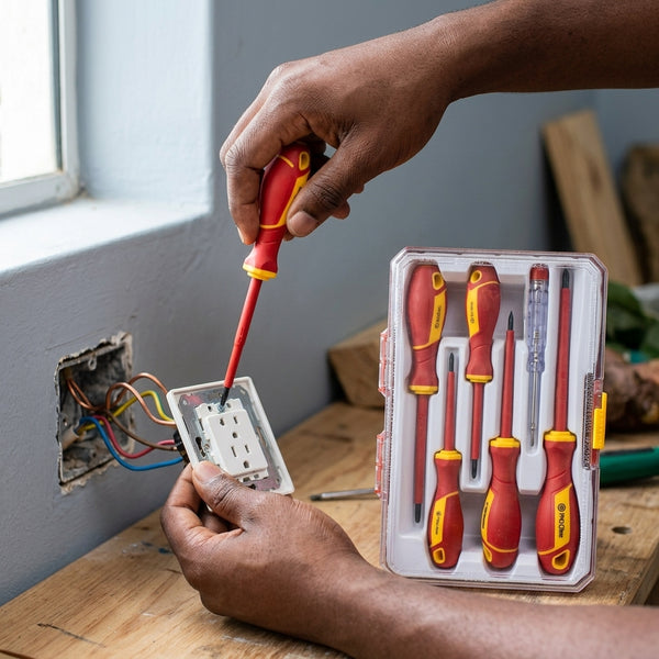 Person using the 6-Piece Insulated Screwdriver Set with Voltage Tester to install an electrical outlet.