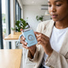 Woman holding a Cartoon Cute Design 10W Output Power Bank in a bright interior setting, showcasing its playful design.