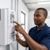 Person operating the 7.5kW Three-Phase Solar Pump Inverter in a controlled environment.