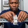 DC Circuit Breaker 32A High Voltage Protection Switch being installed by a technician in an electrical panel.