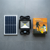 30W Solar Floodlight with Motion Sensor, solar panel, and packaging displayed on a gray surface.