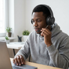 FX-07 Wired Headset with Microphone in use by a young man during an online meeting.