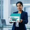 Woman holding 16-Channel AHD CCTV Camera Security Kit box in an office setting with laptop.