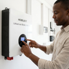 User interacting with 48V 100Ah Lithium-Ion Battery Wall Mount module display.