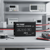 30A DC power transformer 24v to 12v displayed on a workbench with electric equipment.