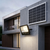 200W Solar Floodlight mounted on a wall with a solar panel, illuminating an outdoor area for practical lighting.