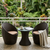 3-Piece Rattan Outdoor Bistro Set featuring two chairs and a table on a balcony with lush greenery.