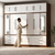 Large Modern Wardrobe with Mirrors in a stylish room with a person organizing clothes.