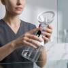 Person holding an Ear Cleaning Syringe with a transparent reservoir for personal ear-care.