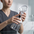 Person holding an Ear Cleaning Syringe with a transparent reservoir for personal ear-care.