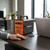 150W Portable Solar Generator LiFePO4 220V Kit powering a laptop in a modern office setting.