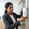PIR Motion Sensor Home Surveillance Unit installation by a professional in an office setting.