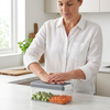 Woman using Premium Vegetable Dicer & Food Chopper to chop vegetables in her kitchen.