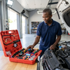 Water Tank Leak Detection Test Kit shown with tools in a red case, man inspecting equipment in automotive garage.