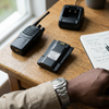 7.4V 1800mAh Li-Ion Battery Pack placed next to a radio on a wooden table, showcasing rechargeable technology.