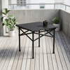 Folding Outdoor Table with Cross-Brace Frame on a balcony with a mug and plants.