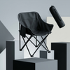 Black Folding Moon Chair displayed on a pedestal, showcasing its foldable design and spacious seat.