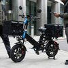 16-Inch Electric Delivery Cargo Bike with black carrying bags, ideal for efficient deliveries on city streets.