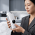 A woman holding a Portable Bottle Warmer in a modern kitchen, showcasing its sleek, compact design.