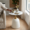 Modern Round Marble-Style Side Table beside a sofa with a coffee cup and decorative vase on top.