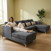 Modern Plush Lounge Couch with Cushions featuring a woman relaxing with a mug, soft gray upholstery and cozy cushions.
