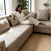 Woman relaxing on a Modern Modular Corner Sofa Set while reading a book in a cozy living room.