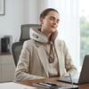 Woman using a Contoured Neck Support Pillow while relaxing in an office chair.