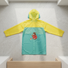 Childrens Hooded Raincoat featuring a colorful design with a bear character and a hood for rainy weather protection.