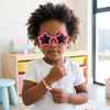 Childrens Hair Accessories & Sunglasses Set featuring a child in star-shaped sunglasses and a colorful beaded bracelet.