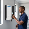 Person using the 48V 5.5kW Solar Inverter with WiFi Dongle mounted on a wall.