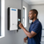 Person using the 48V 5.5kW Solar Inverter with WiFi Dongle mounted on a wall.