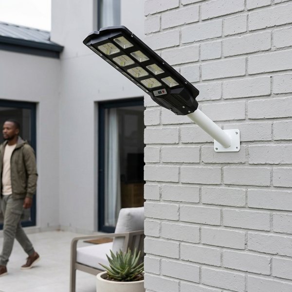 500W Solar Street Light with Motion Sensor mounted on wall near person walking outside.