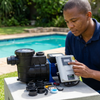 PSP16LT-14M-96V-750W Solar Pool Pump and controller with accessories shown by a person near a swimming pool.