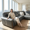 L-Shaped Sectional Sofa in a modern living room with a woman seated comfortably on it.