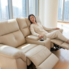 Woman relaxing in a 3-Piece Reclining Sofa Set, featuring a reclining loveseat with cup holders.