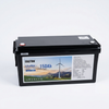 12.8V 150Ah LiFePO4 Lithium Battery in a black casing with safety labels and wind turbine background.