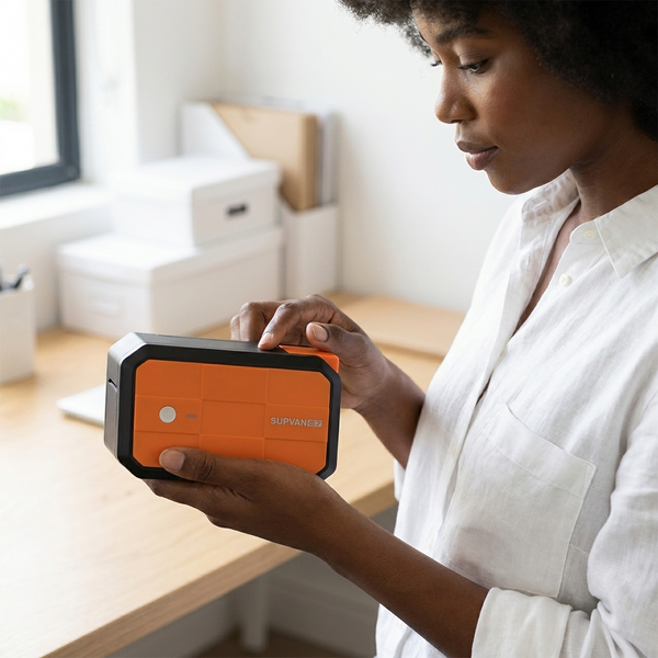 Person using the Power Box Label Printer G18 in an organized home office setting.