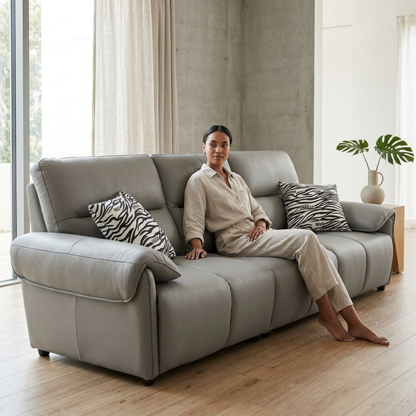 Comfortable living space featuring a woman relaxing on a stylish 3-Seater Sofa with decorative pillows.