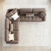 L-Shaped Sectional Sofa in a modern living room setting, featuring brown leather upholstery and decorative pillows.