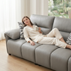 Woman relaxing on a 3-Seater Sofa in a cozy living space with a cup of coffee.