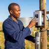 4ssHi H3.5 260 280V 2200W Borehole Pump being operated by a technician in a field.