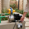 750W Automatic Water Pressure Pump with Gauge installed outdoors, showcasing the gauge and electrical plug.