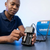 Man using a Double Battery Charger to charge batteries, showcasing its two-bay design and convenience.