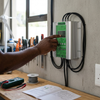 User interacting with the 24V 600W Wind Turbine and Solar MPPT Controller in a workspace setting.