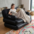 Woman relaxing on a 5-in-1 Inflatable Air Couch while reading a book with a blanket.