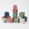 12-Piece Squeeze & Stack Silicone Baby Building Blocks in various colors, perfect for sensory play and stacking.