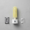 Electric Cleaning Brush with Rotating Brush Head and accessories on a gray surface.