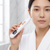 Electric Skin Care Pen with Interchangeable Needle Tips held by a woman in a robe, showcasing its design and digital display.