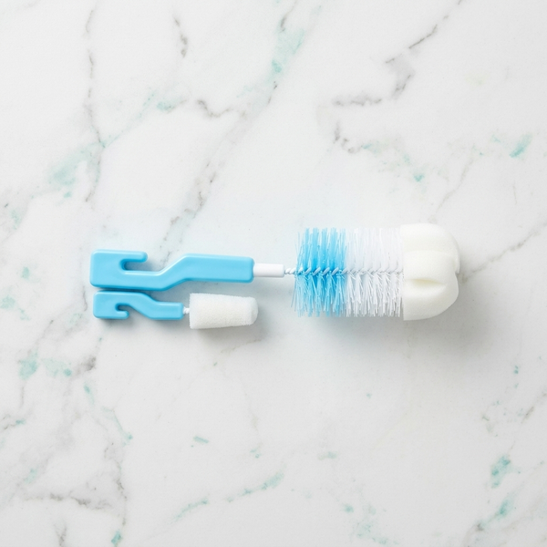2-in-1 Baby Bottle & Teat Cleaning Brush Set with sponge tips and nylon bristles on a marble surface.